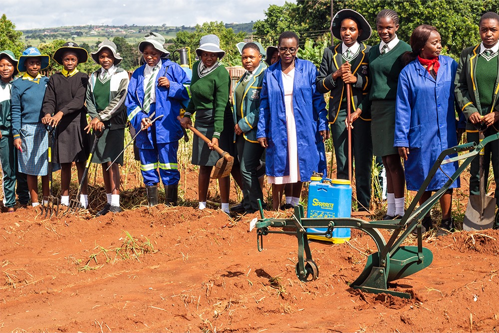 Students engaged in agricultural practical training with modern farming equipment